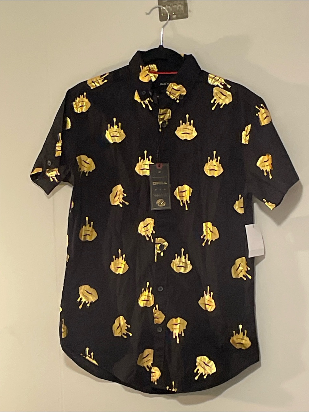 Drill Clothing Co. Men's Black Short-Sleeve Button-Up Shirt with Gold Lip Print.